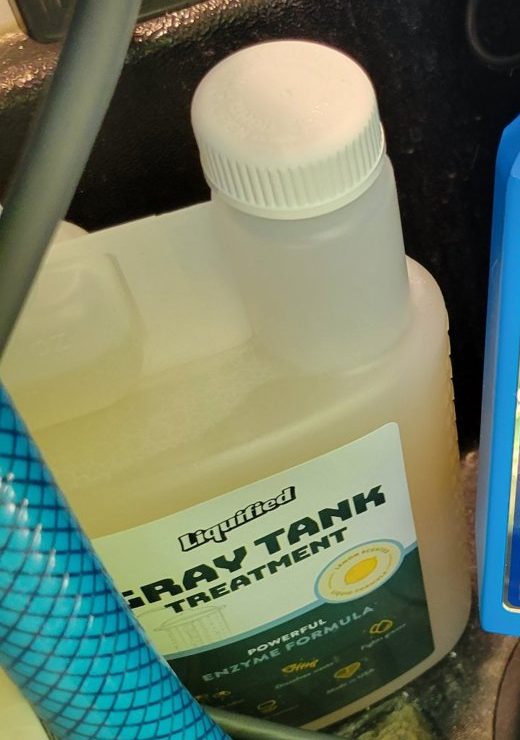 Biscuit's Liquified Gray Tank Treatment bottle in the camper water bay